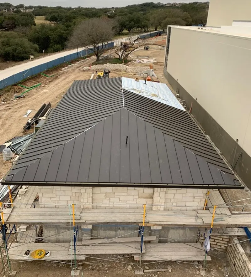 Metal roof new construction with scaffolding in Goldenrod