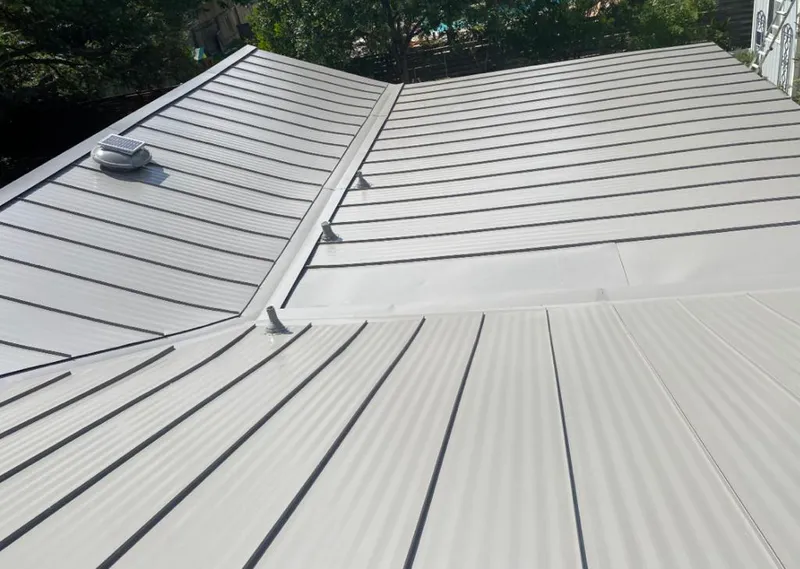 Solar attic fan installed on a metal roof for Roof Ventilation in Goldenrod